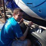 Matt Inglesby putting reflective strips on the boat hull