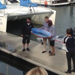 Fedor is presented a surfboard from the local Mayor